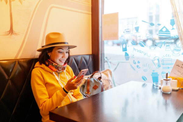 Happy asian woman looking at the social media in smartphone in cafe - Grow Your Instagram Account - Learn How