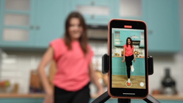 Young girl dancing and making videos for their blogs or social networks. Blogger filming vlog with trend content in kitchen. Online content, likes, stories, popularity, youth subculture. Phone camera POV close up - https://depositphotos.com/609372032/stock-photo-young-girl-dancing-making-videos.html